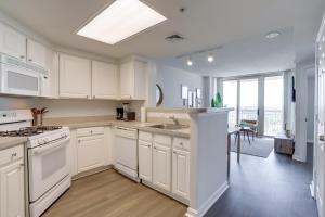 a kitchen with white cabinets and a large window at Spectacular 1 Bedroom Condo At Ballston place With Gym in Arlington