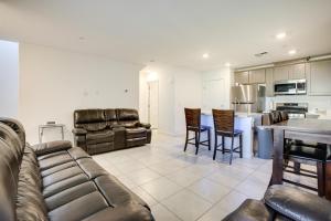 a living room with a couch and a kitchen at Comfy Las Vegas Retreat about 7 Mi to The Strip! in Las Vegas