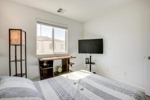 a bedroom with a bed and a flat screen tv at Comfy Las Vegas Retreat about 7 Mi to The Strip! in Las Vegas