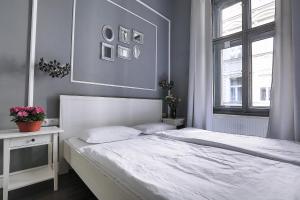a bedroom with a white bed and a window at Two-bedroom Haven In The Old Town in Prague