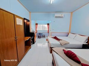 Habitación de hotel con 2 camas y baño en Peace Lanta Mansion en Ko Lanta