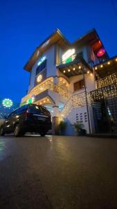 a building with a car parked in front of it at villa paguio hot spring resort in Calamba