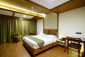 a bedroom with a large bed and a desk and a desk at Taj Mahal Hotel in Hyderabad +21 photos