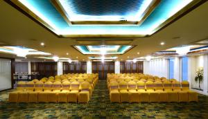a conference room with yellow chairs and a ceiling at Taj Mahal Hotel in Hyderabad