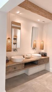a bathroom with two sinks and a large mirror at Havuzlu , şömineli villa 