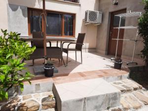 a patio with a table and chairs in a building at Studio Primani in Sečovlje