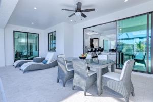 a dining room with a table and chairs at New listing - Amazing new 3beds/3baths Gulf access villa w. heated pool and outdoor kitchen! in Matlacha
