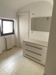 a white room with a dresser and a window at Casa vacanza il Rifugio in Troia