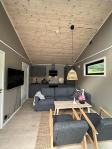 a living room with a couch and a table at Kavliskogen panorama in Isfjorden