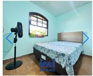 a bedroom with a bed and a camera in a room at Praiana in Guaratuba