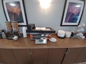 a counter top with a bunch of items on it at Super 8 by Wyndham Cranbrook in Cranbrook
