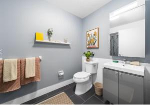 a bathroom with a white toilet and a sink at Glorious 3 Bed 2 Bath In Upper East Side in New York