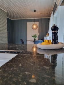 a kitchen with a table with a black and yellow object on it at Stor leilighet med 4 senger sentralt i Førde in Førde