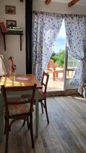 a dining room with a table and chairs and a window at La Flor del Camino Posada in Tanti +51 photos
