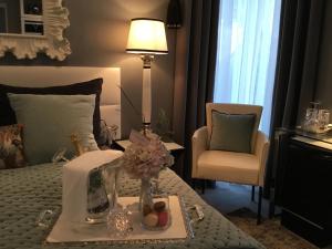 a bedroom with a bed with a table and a chair at Suite Couture in Ernestviller