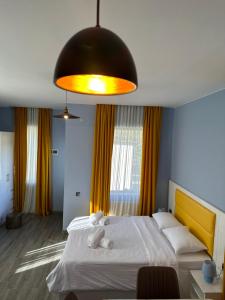 a bedroom with a large bed with a large light at Sunny Sadgeri in Borjomi