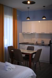 a kitchen with a table and chairs in a room at Sunny Sadgeri in Borjomi