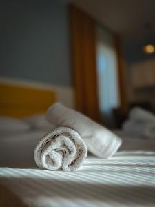 a rolled up towel sitting on top of a bed at Sunny Sadgeri in Borjomi