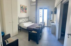 a bedroom with a bed and a table and chairs at B&B UN POSTO AL MARE San Salvo Marina in San Salvo