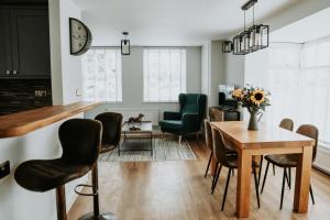 a living room with a table and chairs at Retreat on the Green in Holt