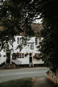 a white building sitting on the side of a street at Retreat on the Green in Holt