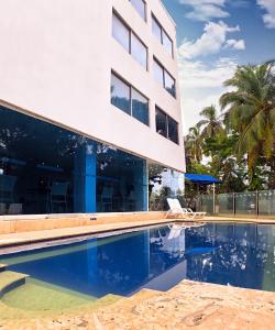 a building with a swimming pool in front of a building at Hotel Oceania Cartagena in Cartagena de Indias