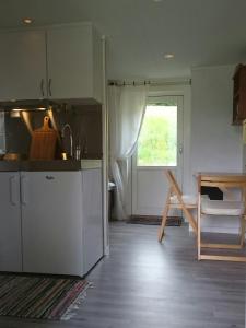 a kitchen with a counter and a table and a window at Telemark Inn - Hytte in Hauggrend