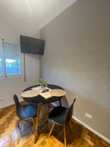 a dining room with a table and two chairs at Ana rent in Boulogne