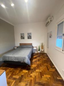 una camera con letto e pavimento in legno di Ana rent a Boulogne