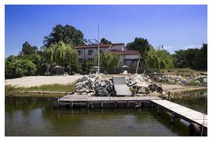 a house on the shore of a lake with a dock at Vila Raluca in Eforie Nord +21 photos