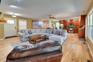 a living room with a couch and a table at Lakefront Gilbertville Haven with Private Boat Dock! in Gilbertsville