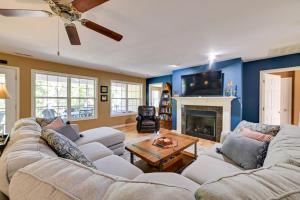a living room with a couch and a fireplace at Lakefront Gilbertville Haven with Private Boat Dock! in Gilbertsville
