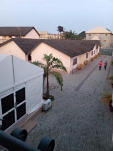 a group of buildings with palm trees in a courtyard at 3TS LUXURY APARTMENTS in Sangotedo