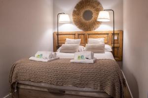 a bedroom with a bed with two pillows and a mirror at Bonito Apartamento en el centro in Madrid