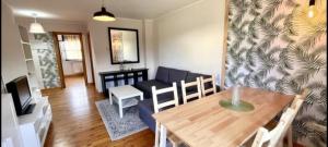 a living room with a blue couch and a table at El Acebu in Colombres +21 photos