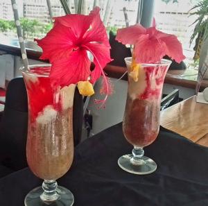 two cocktails sitting on top of a table at Oasis Palms Hotel in Nadi