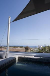 a swimming pool with a view of the ocean at Griseo Villas in Karterados