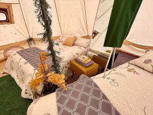 a room with two beds in a tent at M.Ruth Retreats in the Orchard 