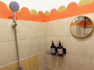 a shower with two bottles of wine on a wall at Villaok in Kuta +32 photos