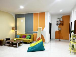 a living room with a couch and a table at Villaok in Kuta