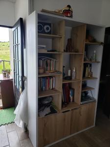 a book shelf filled with books in a room at Casita del páramo Sarmora in La Calera