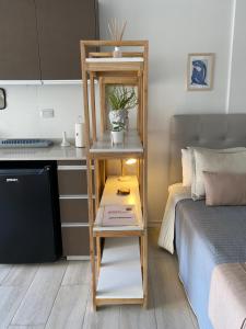 a room with a shelf next to a bed at MAO Buenos Aires - Apt. en Recoleta in Buenos Aires