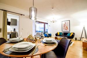 a dining room with a wooden table and chairs at SCANDIC-Apartment, Balkony, Free Coffee, 80m2 in Pforzheim