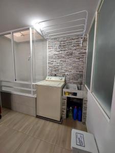 eine Küche mit Spüle und Ziegelwand in der Unterkunft Apto vacacional DENIS T in Tunja