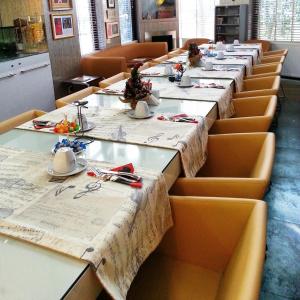 a long row of tables in a restaurant with tablesearcher at Jazz Hotel Nisantasi in Istanbul