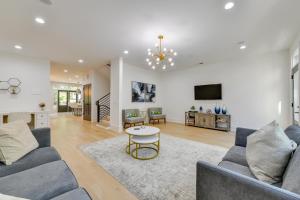 a living room with a couch and a table at Luxe Townhome in South End Charlotte Near Uptown! in Charlotte
