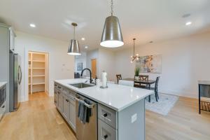 a kitchen and living room with a sink and a table at Luxe Townhome in South End Charlotte Near Uptown! in Charlotte