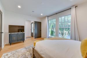 a bedroom with a bed and a large window at Luxe Townhome in South End Charlotte Near Uptown! in Charlotte