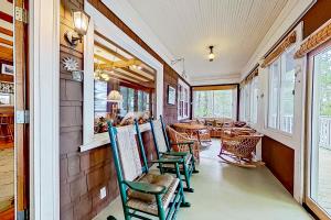 a room with chairs and tables and windows at American Dream on Lake Winnipesaukee in Meredith