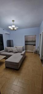 a large living room with a couch and a table at Vlora Home in Vlorë
